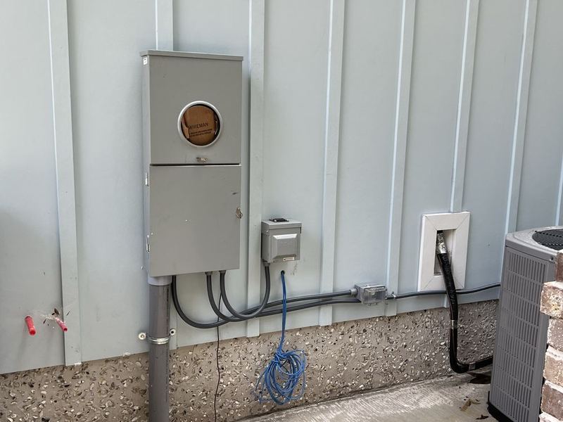 Meter base and disconnect installed on an exterior wall