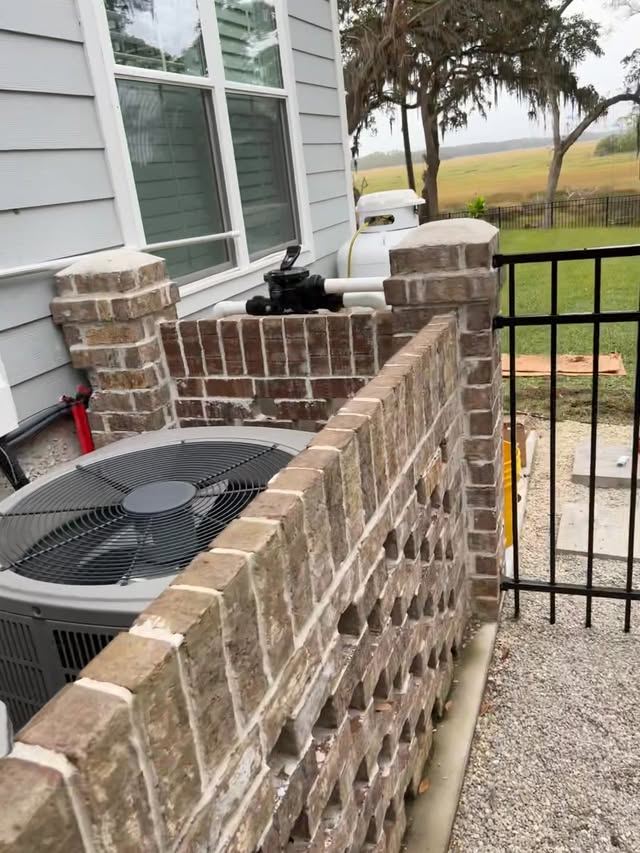 Condenser disconnect mounted on an exterior brick wall