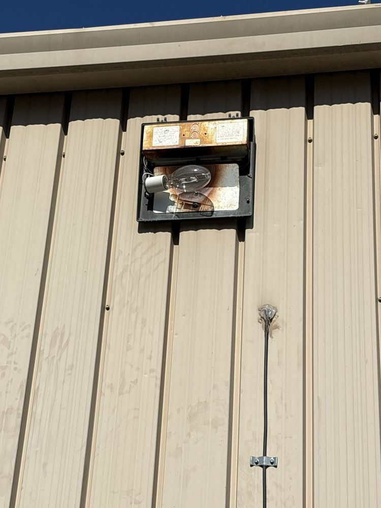 Wall pack light fixture on a metal building